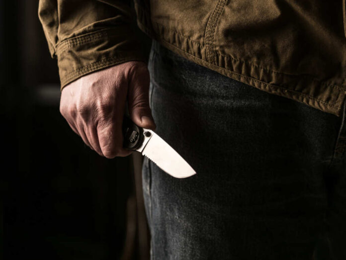 Man,Holding,A,Knife,In,A,Threatening,Stance,Ready,To