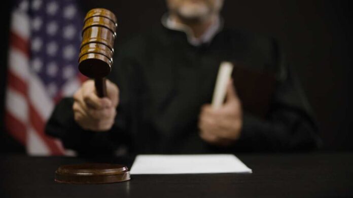 Male,Judge,Hitting,Gavel,,Calling,Court,Members,To,Stand,,United