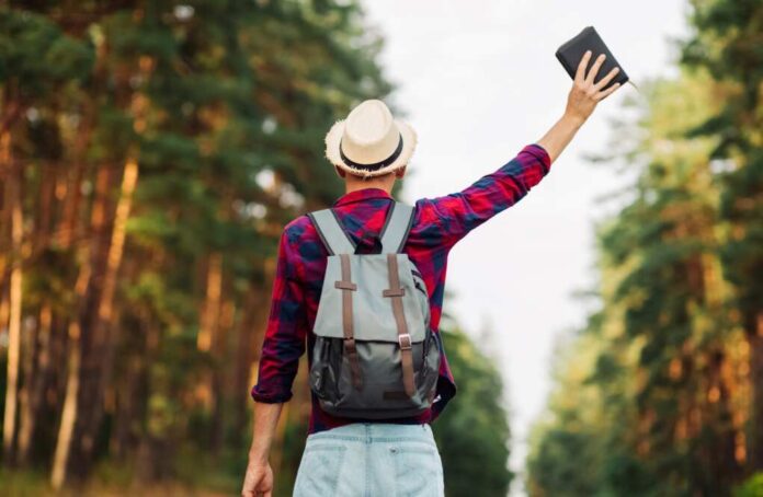 Christian,Man,With,Outstretched,Hands,Holds,A,Bible,In,The