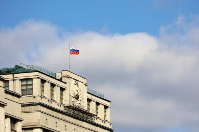 Russian,Flag,On,The,Parliament,Building,In,Moscow,On,Background