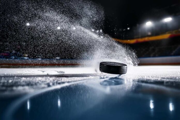 Close-up,Of,A,Hockey,Puck,Falling,Onto,The,Ice,Surface