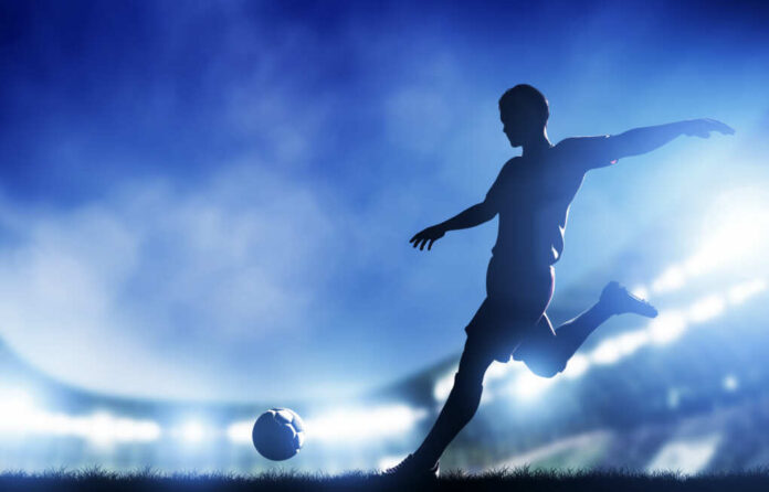 Football,,Soccer,Match.,A,Player,Shooting,On,Goal.,Lights,On