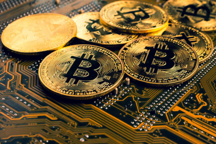 Golden,Coins,With,Bitcoin,Symbol,On,A,Mainboard.