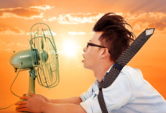 The,Heat,Wave,Is,Coming,business,Man,Holding,A,Electric,Fan