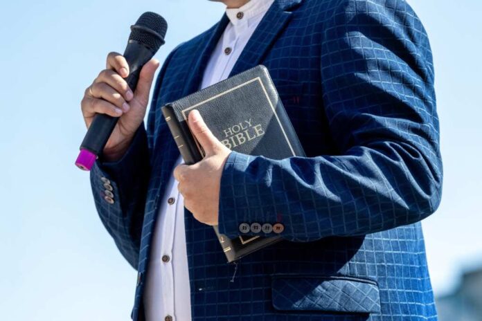 Pastor,With,A,Bible,In,His,Hand,During,A,Sermon.