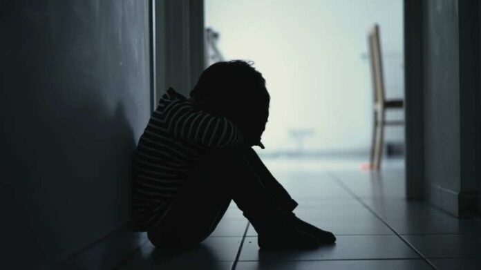 Sad,Child,Suffering,From,Depression,Sitting,Alone,In,Corridor,Feeling