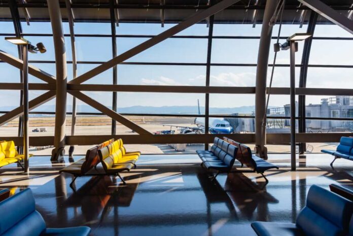 Airport,Terminal,Glass,Window,With,View,Of,Airplane,,Airport,Interior