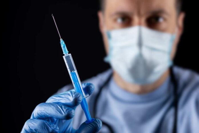 Doctor,,Or,Scientist,Hand,In,Blue,Nitrile,Gloves,Holding,Flu,