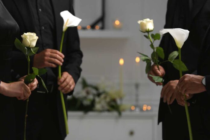 People,With,Flowers,Indoors,,Closeup.,Funeral,Ceremony