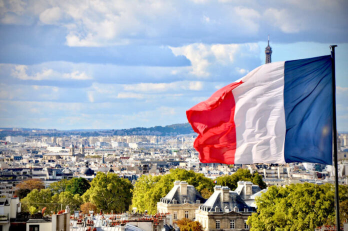 Paris,,France,Flag,With,Eiffel,Tower,Peeking,In,The,Back.