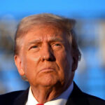 Trump Brands Greene “TRAITOR” Over Epstein Truth Close-up portrait of a serious-looking political figure outdoors