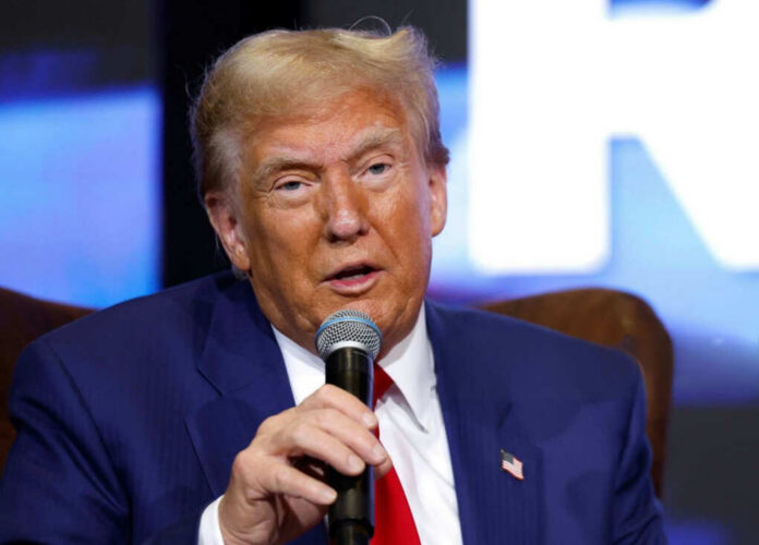 shutterstock2567881811jpg A man in a blue suit speaking into a microphone