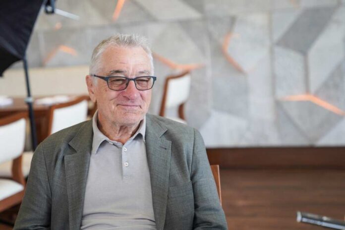 Elderly man in a casual outfit smiling in a modern interior
