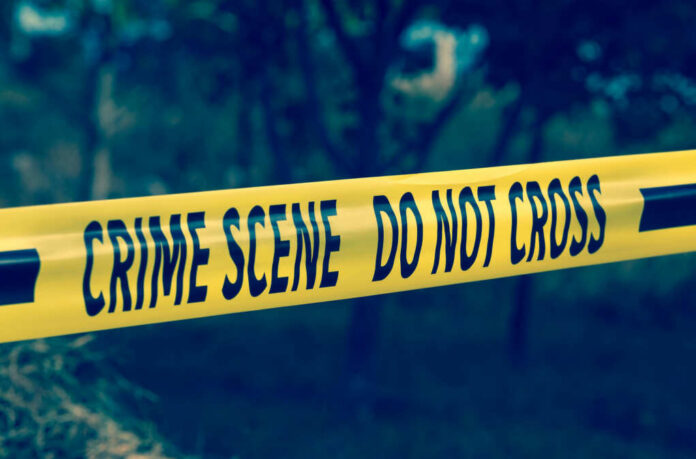 Yellow crime scene tape reading DO NOT CROSS