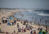 Bacteria Overload Turns Coastal Haven Toxic A busy beach with people sunbathing and playing in the water
