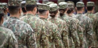 Line of soldiers in camouflage uniforms standing in formation
