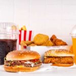 A variety of fast food items including burgers, fries, and drinks