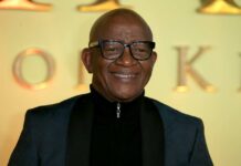 A smiling man in formal attire posing for a photo