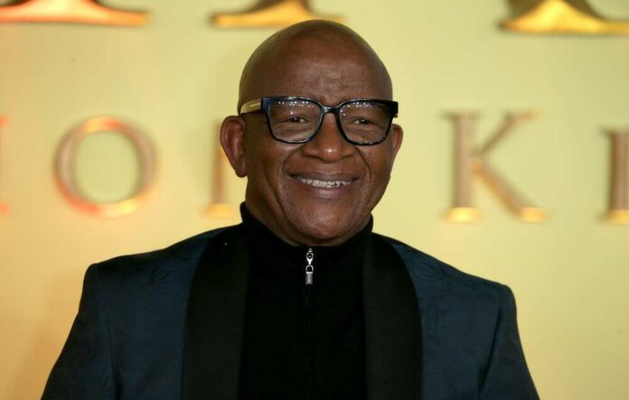 A smiling man in formal attire posing for a photo