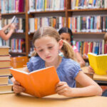 Children reading books in a library