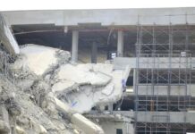 Damaged building structure with exposed debris and scaffolding