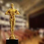 Golden Oscar trophy displayed in a theater setting