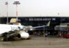 An airplane parked at Ben Gurion Airport with the terminal in the background