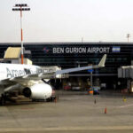 An airplane parked at Ben Gurion Airport with the terminal in the background