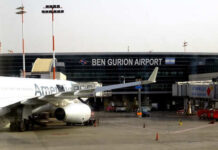 An airplane parked at Ben Gurion Airport with the terminal in the background