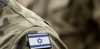 Close-up of a military uniform with an Israeli flag patch