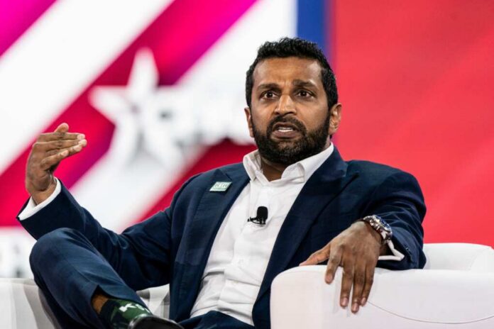 A man in a suit speaking passionately during a conference panel discussion