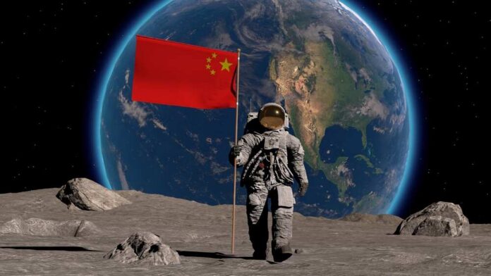 shutterstock_2354805785.jpg An astronaut on the moon holding a Chinese flag with Earth in the background