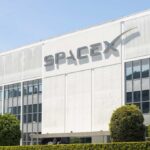 Exterior view of the SpaceX building with a prominent logo
