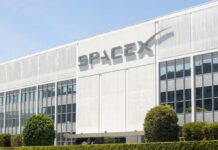 Exterior view of the SpaceX building with a prominent logo