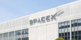 Exterior view of the SpaceX building with a prominent logo