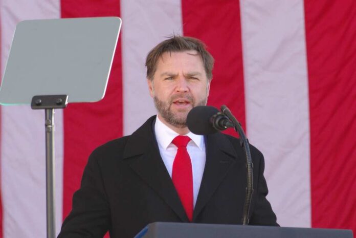 Man speaking at a podium with an American flag backdrop
