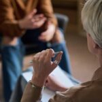 Two individuals engaged in a conversation during a counseling session