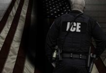ICE agent standing in front of an American flag