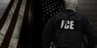ICE agent standing in front of an American flag