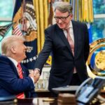 Two men shaking hands in an office setting