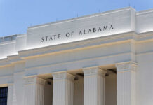 Facade of a government building with the words 'STATE OF ALABAMA' displayed prominently