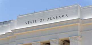Facade of a government building with the words 'STATE OF ALABAMA' displayed prominently