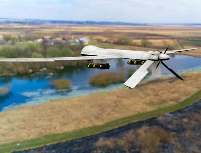 shutterstock2138644875jpg A military drone flying over a rural landscape with a river