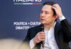 Musk’s AI Case Falls Apart—Timing Over Truth Individual speaking at a conference, holding a microphone