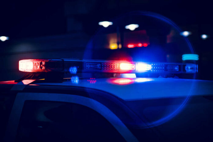 Closeup,Of,Police,Lights,On,Dark,Street,At,Night Close-up of police car lights flashing at night