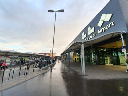 Exterior view of Luton Airport with a cloudy sky