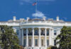 White House Fortress: What’s Behind the Walls? The White House with an American flag flying against a blue sky