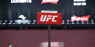 UFC weighing scale with a red sign in front