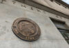 Bronze seal of the Department of the Treasury mounted on a stone wall