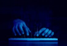 Canvas Attack Sparks OUTRAGE – Who’s Accountable? Hands typing on a keyboard with a digital binary background